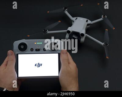 USA - July 14, 2022: A DJI remote controller, which has been newly-introduced in 2022, is shown featured with a Mini 3 Pro drone / UAV. Stock Photo