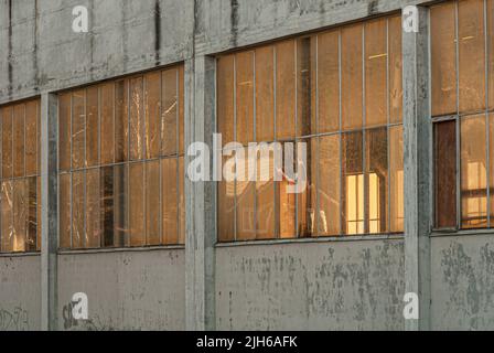 Mandal, Norway - december 24 2008: Sun shining through the windows of a large industrial building. Stock Photo
