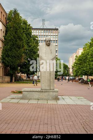 Lodz, Poland - July 08, 2022: Monument to Leon Schillerin at alley of Leon Schiller against cloudy sky Stock Photo