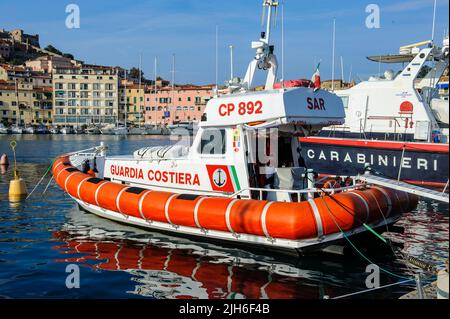 SAR Search and Rescue speedboat of the Italian Coast Guard Guardia Costiera in the harbour of Portoferraio moored at the quay, behind it speedboat Stock Photo