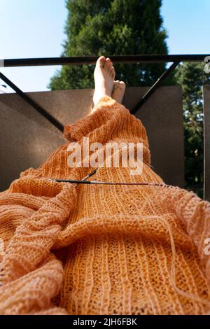 Knitted blanket with knitting needles Stock Photo