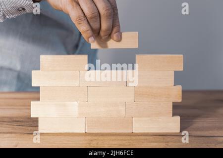 Creating a stable foundation for the company's operations, Business development based on solid foundations Creative concept, Entrepreneur builds a wal Stock Photo