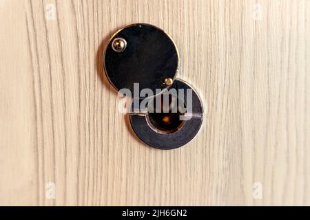 door peephole close-up on a modern reliable front door. copy space  Stock Photo