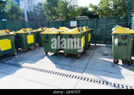 Collection point with several large trash containers for disposing of glass aluminum cans paper cardboard and plastic in a city as a concept for waste Stock Photo