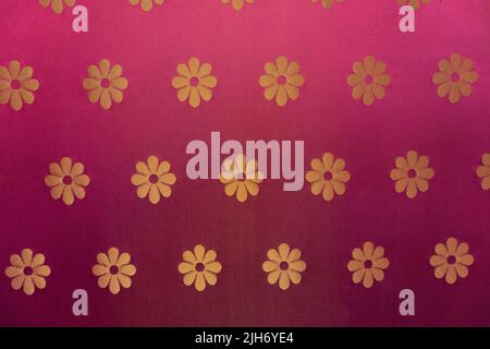 Close up of historical bordeaux red linen fabric wall wallpaper with golden flower ornament pattern on it for use as distinguished noble backdrop back Stock Photo