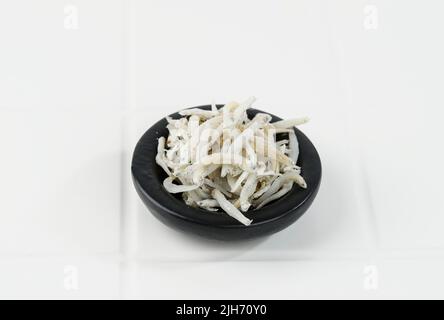 Teri Medan, White Small Dried Anchovies Isolated on White Table Stock Photo
