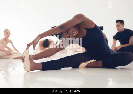 Dance is your pulse, your heartbeat. a group of ballerinas warming up before practicing their routine. Stock Photo