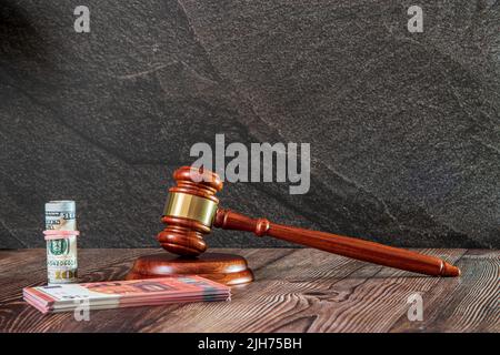 Judges hammer, Dollard bank notes, Euro bank Notes, on a wooden background. Concept for a financial judgments Stock Photo