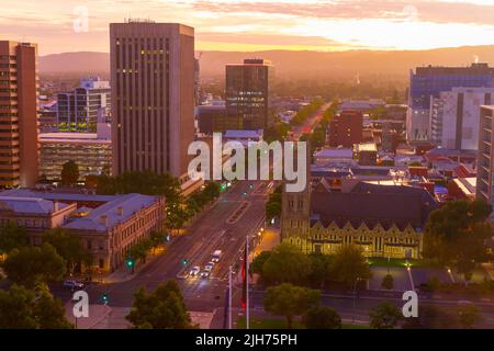 Adelaide in South Australia, seen at dawn from Victoria Square looking east along Wakefield Street, with the Mount Lofty Ranges in the background. Stock Photo