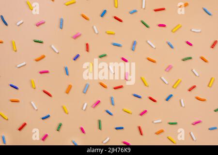 background of sprinkles for sweets on a beige background.The concept of celebrating a birthday, party or other holidays.fashionable,sweet background.  Stock Photo