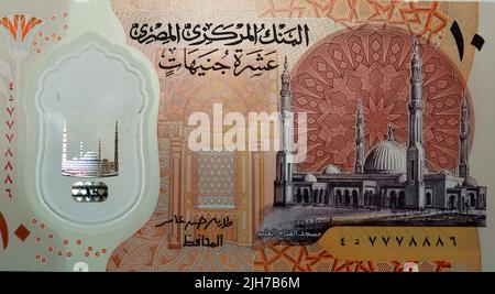 Large fragment of the obverse side of the new first Egyptian 10 LE EGP ten pounds plastic polymer banknote features Administrative capital's grand mos Stock Photo