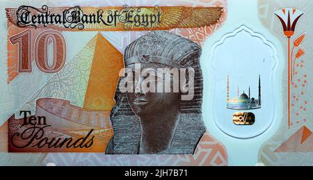 Large fragment of the reverse side of the new first Egyptian 10 LE EGP ten pounds plastic polymer banknote features a statue of Ancient Egyptian queen Stock Photo