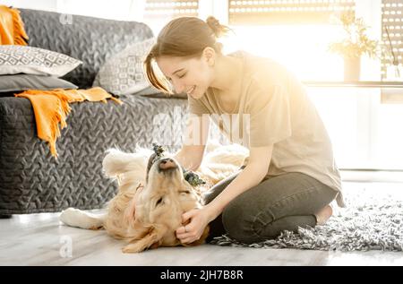 pretty-girl-hugging-golden-retriever-dog-and-lying-in-bed-female