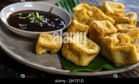 Tahu Goreng is popular street food of deep fried bean curd from Indonesia Stock Photo