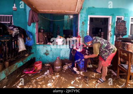 Garut, Indonesia. 16th July, 2022. A man cleans his house after flood in Garut, West Java, Indonesia, July 16, 2022. Due to high intensity of rain-fall, the overflow of Cimanuk River damaged houses in the region. Credit: Septianjar/Xinhua/Alamy Live News Stock Photo