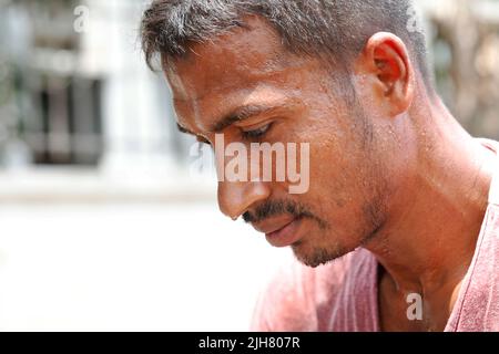 Dhaka, Bangladesh - July 16, 2022: There is no rain even in the rainy season; a rickshaw driver is sweating in the scorching sun and scorching heat at Stock Photo