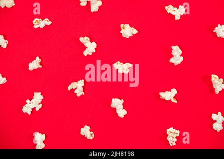 Popcorn on a red background, close-up view from above Stock Photo