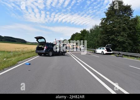 16 July 2022, Bavaria, Ruderatshofen: Emergency services and fire department personnel are on the scene of the accident on the B12. A female driver was seriously injured in a head-on collision in the Swabian district of Ostallgäu. The motorist was trapped in her car in the accident on Saturday, police said. The woman was in the area of an overtaking opportunity on the federal highway 12 near Ruderatshofen for as yet unexplained reasons left into oncoming traffic. There she crashed head-on into an oncoming car. Photo: Nikolas Schäfers/dpa - ATTENTION: license plate and lettering has been pixela Stock Photo