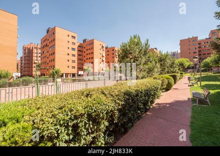 Walk between gardens in the common areas of a residential housing development with basketball courts Stock Photo