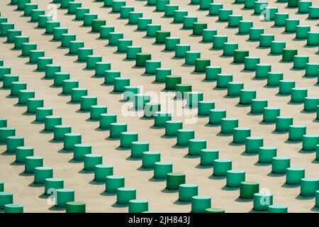 Cropped view of the concrete grey building wall elements with green plastic objects Stock Photo