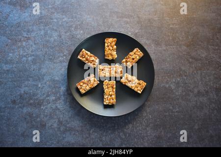 Chikki Indian brittle sweet food made from peanut Stock Photo