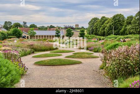 The Oudolf Field garden at Hauser and Wirth Art Gallery at Bruton in Somereset UK with the medieval village dovecote on the distant hill Stock Photo