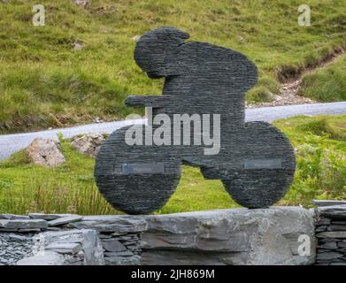 Slate sculpture of a racing cyclist made at the Honister slate mine at Honister Pass a popular cycling route in the Lake District Cumbria UK Stock Photo
