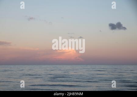 Clouds during sunset on a beach Stock Photo