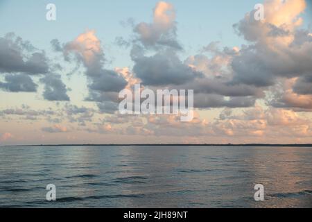 Clouds during sunset on a beach Stock Photo