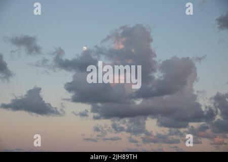Clouds during sunset on a beach Stock Photo