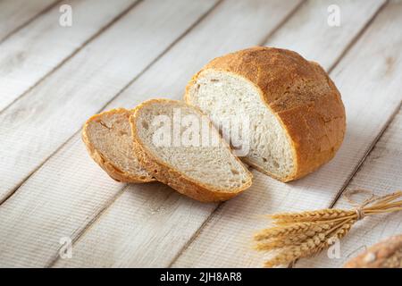 Fresh baked sliced loaf of bread with wheat Stock Photo