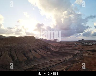 A mesmerizing view of a golden sunset over mountains Stock Photo