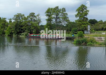 Canal barge / narrow boat entering the lock on the river Avon at Saltford, Bristol. Summer 2022. June Stock Photo