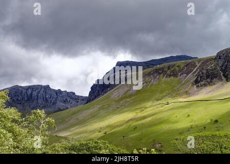 Dark clouds forming over the Scafell mountain range on a summers day Wasdale Lake District National Park Cumbria England UK Stock Photo