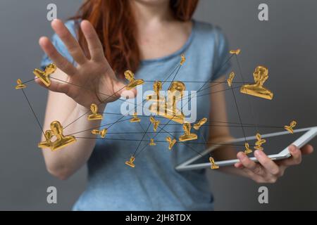 A woman holding a tablet and touching a floating render of networking signs Stock Photo