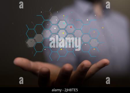A person holding on a floating digital render of a binary code network Stock Photo