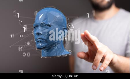 A man touching a floating render of the head Stock Photo