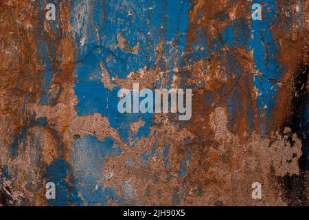 Old wall with scraps of blue paint, grunge texture Stock Photo