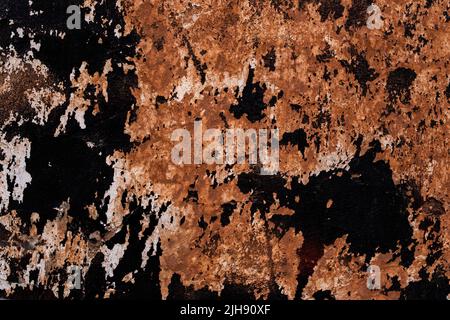 Old weathered mud wall background with scraps on black and white paint grunge texture Stock Photo