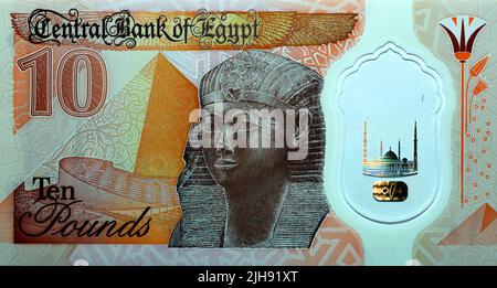 Large fragment of the reverse side of the new first Egyptian 10 LE EGP ten pounds plastic polymer banknote features a statue of Ancient Egyptian queen Stock Photo