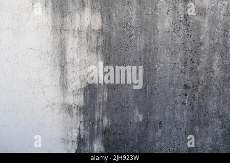 Old weathered raw concrete wall with white damp stain Stock Photo