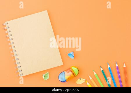 Spiral notepad with colored pencils. Stock Photo