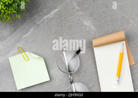 Open notepad on marble background. Stock Photo