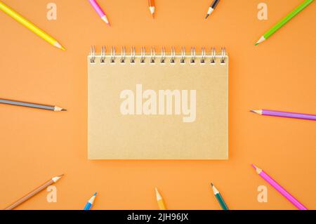 Spiral notepad with colored pencils. Stock Photo