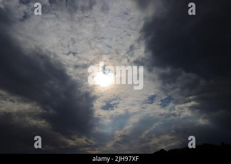 sunshine between dark clouds, wide-angle shot Stock Photo