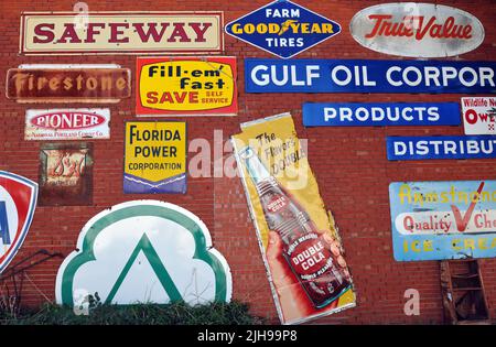 Vintage advertising signs decorate the outside brick wall of the Sandhills Curiosity Shop, a Route 66 roadside attraction in Erick, Oklahoma. Stock Photo