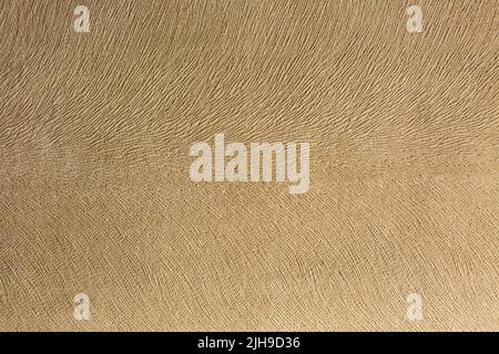 Artificial suede light brown background, textile imitation, velvet texture. Stock Photo
