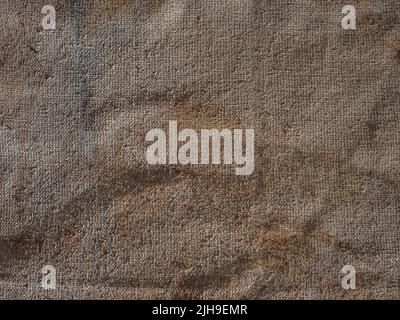 wrinkled and painted burlap or hessian sacking as a background Stock Photo