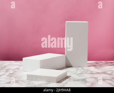 Product podium and pedestal. Suitable for Product Display and Business Concept. Pastel pink background and marble table. Modern aesthetic. Stock Photo