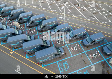 Top view of Amazon Prime electric delivery vans, parked at  the logistics hub of Amazon. Turin, Italy - July 2022 Stock Photo